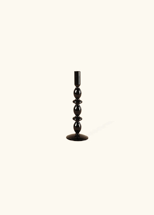 Introducing our Midnight Glass Candlesticks: A perfect fusion of classic charm and modern style. With a uniquely retro-inspired design and a sleek glass construction, these candlesticks effortlessly add sophistication to any space. Elevate your ambiance with this exquisite blend of vintage allure and contemporary elegance. Additional features include black glass candlesticks, available in 3 styles, modern retro style, and unique shapes.