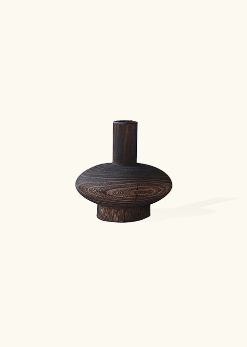 A unique wooden design named the chuck from the Mara Dark Wood Vase Collection, part of a symphony of nature and creativity. Crafted from dark, lustrous wood, these remarkable vases feature captivating designs that blend the raw beauty of wood with imaginative forms. Opt for the Mara Dark Wood Vase Collection to infuse your decor with rich natural tones and a touch of artistic inspiration, transforming your space into a realm of sophisticated charm and individuality.