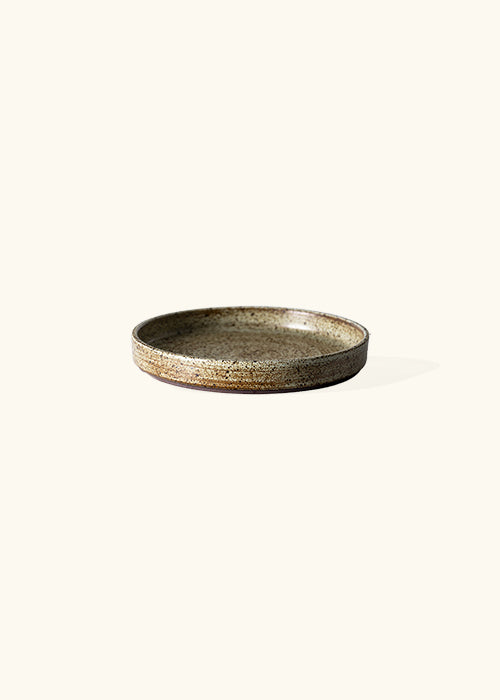 Handmade stone small plate, measuring W19cm x H2.7cm. Featuring a rugged yet sleek style, this plate is part of a comprehensive set of raw pottery dishes and mugs designed for versatile dining needs