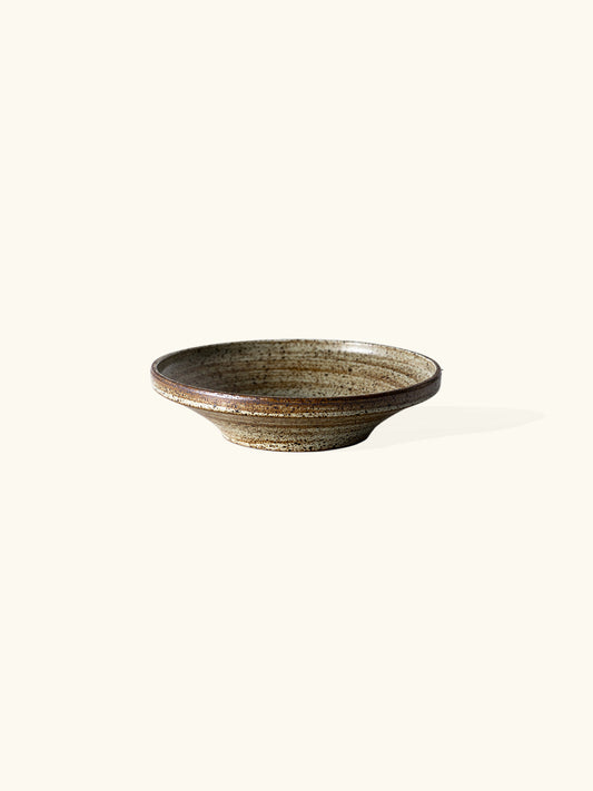 Handmade stone small bowl, measuring W18.3cm x H4.5cm. Exhibiting a rugged yet sleek style, this bowl is part of a comprehensive set of raw pottery dishes and mugs designed for versatile dining needs.