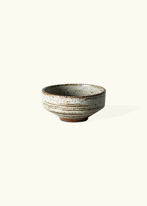 Handmade stone tapered dish, measuring W11.7cm x H5.5cm. Featuring a rugged yet sleek style, this dish is part of a comprehensive set of raw pottery dishes and mugs designed for versatile dining needs.